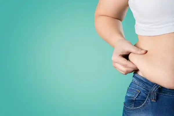 Image of woman pinching her love handles to show weight gain South Yardley